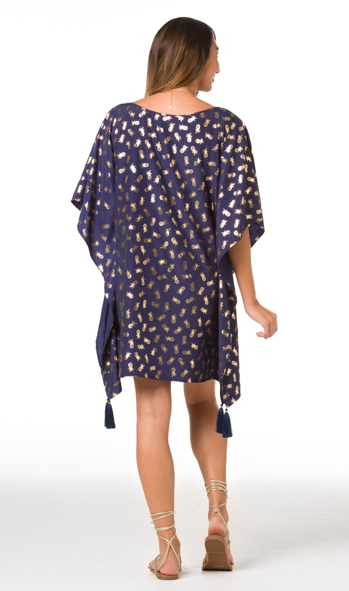 Gold foil print dress with batwing sleeves, back view.
